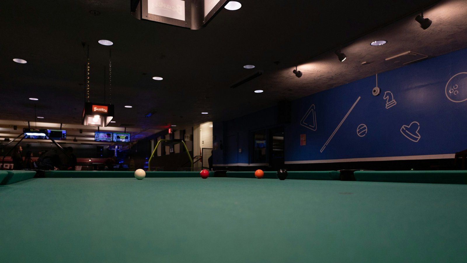 Premium snooker table illuminated in a dark room